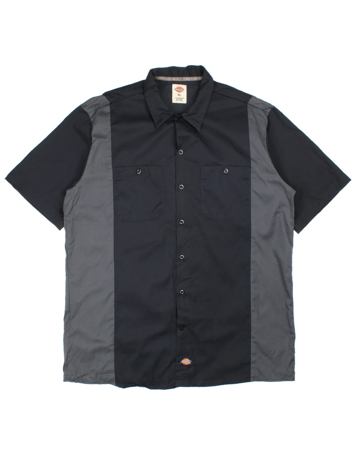 Vintage Dickies Work Shirt in a black and grey colourway, button up and has double chest pockets with the logo embroidered on the front.