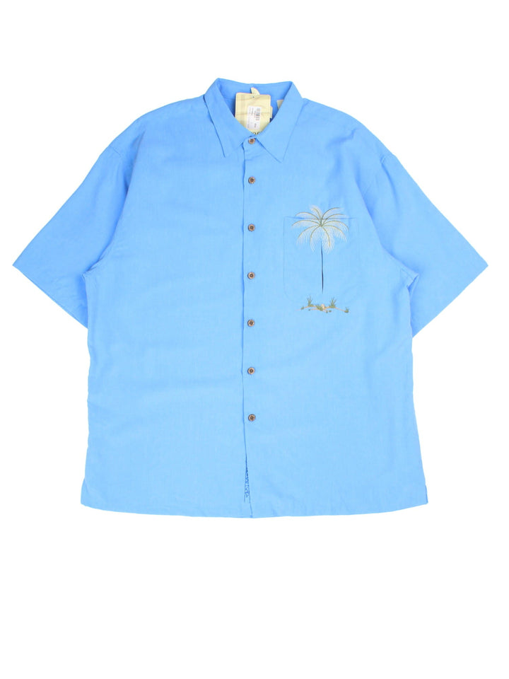 Vintage Hawaiian Shirt in a blue colourway, palm tree embroidery detail and front pocket.