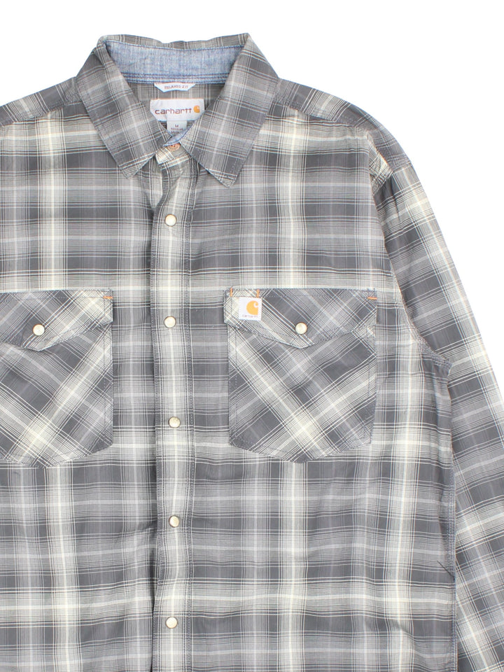 Carhartt Shirt in a grey/white checked colourway. Button popper fastening, front patch pockets and branded logo patch.