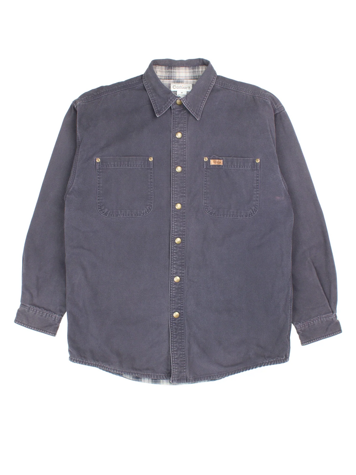 Carhartt Work Shirt in a blue colourway, buttons up and has double chest pockets with the logo tab embroidered on the front.