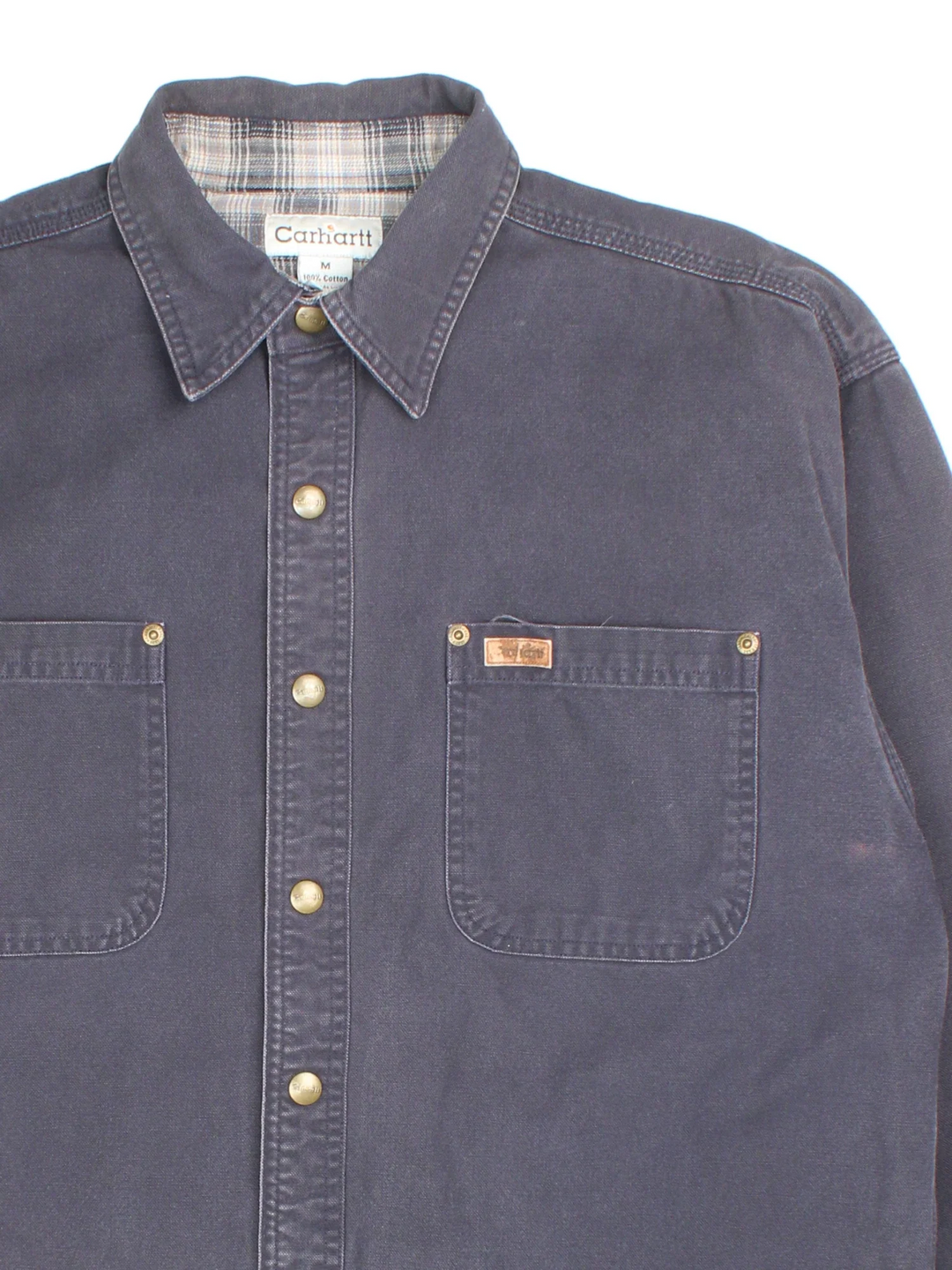 Carhartt Work Shirt in a blue colourway, buttons up and has double chest pockets with the logo tab embroidered on the front.