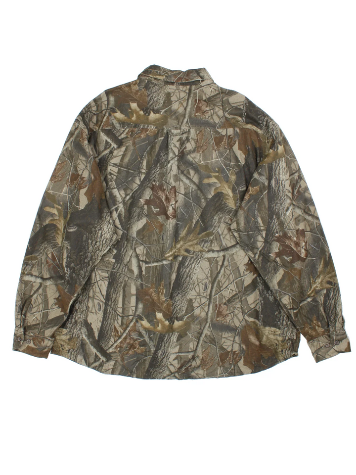 Woolrich Real Tree Camo Shirt in a green and brown colourway, button up and has double chest pockets with the logo embroidered on the front.