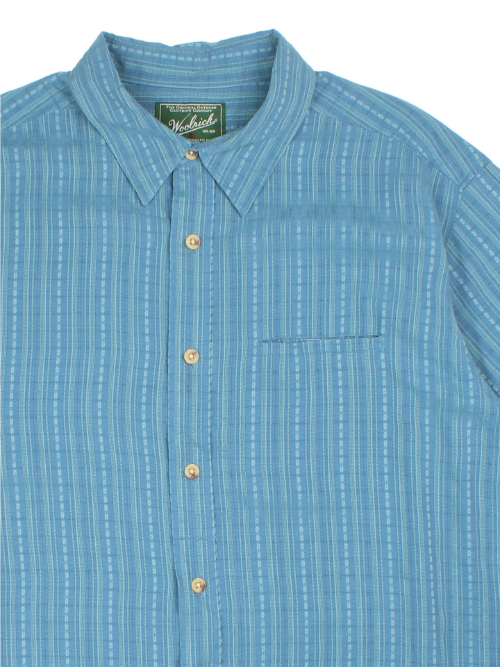 Woolrich Short Sleeve Summer Shirt in a blue striped colourway, similar to Cuban style, button up and has a chest pocket with a velcro closure.