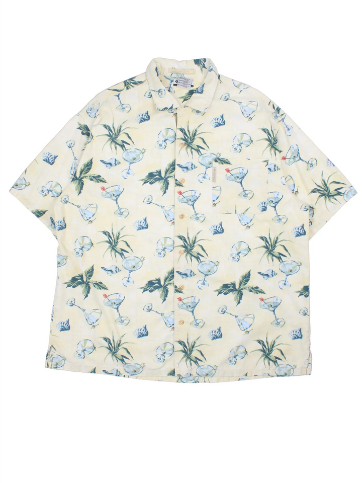 Columbia Hawaiian Shirt in a tan colourway with floral and cocktail all over print, button up and has a chest pocket with the logo embroidered on.
