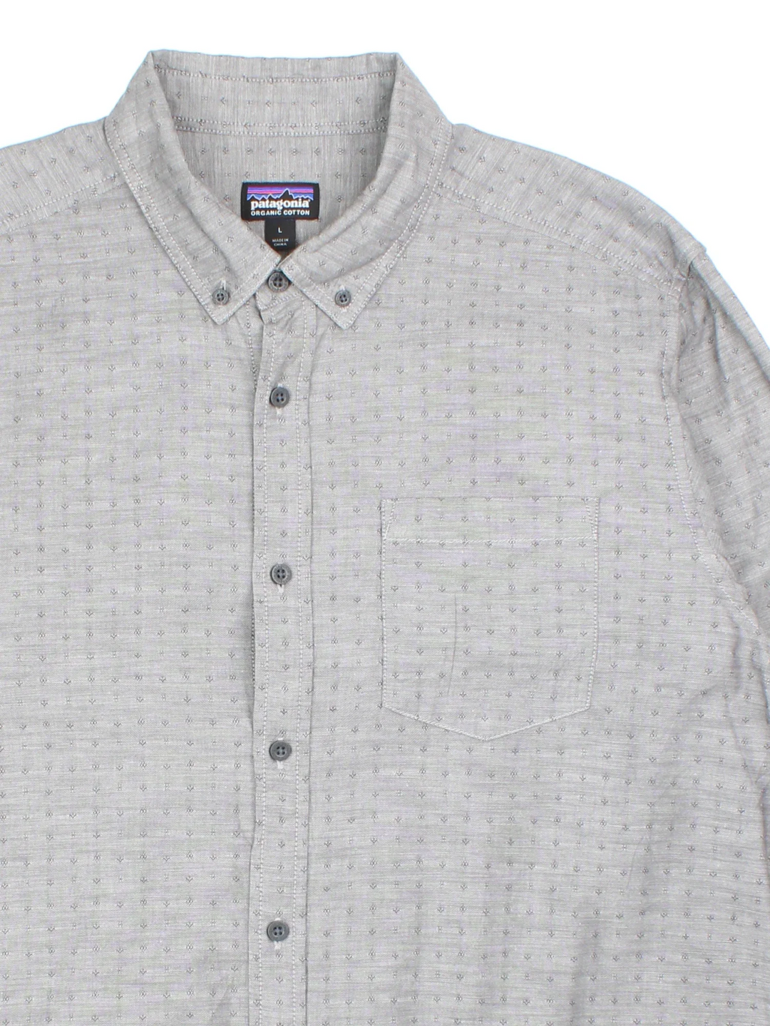 Patagonia Shirt in a grey colourway, button up and has a chest pocket, and the logo tab embroidered on the side.