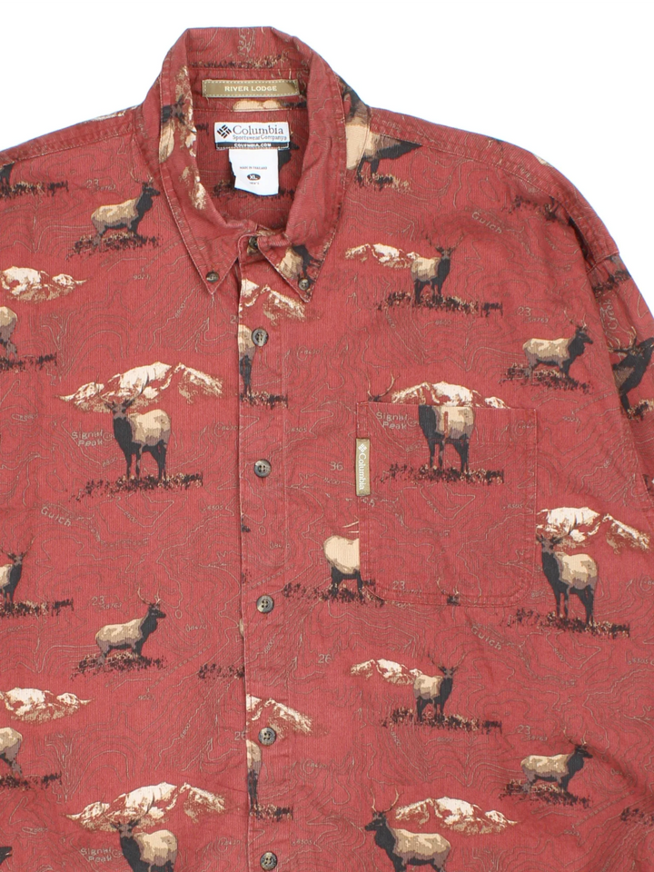 Columbia River Lodge Deer Shirt in a red colourway with all over deer print, button up and has a chest pocket with the logo tab embroidered on the front.