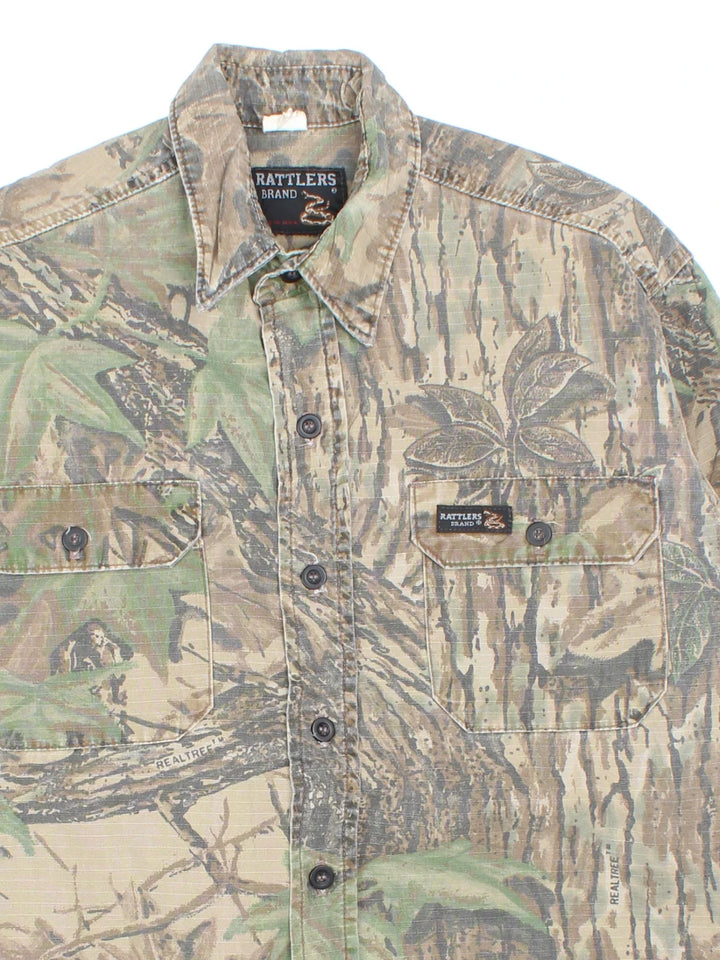 Vintage Rattlers Real Tree Camo Shirt in a green and brown colourway, button up and has double chest pockets with the logo embroidered on the front.