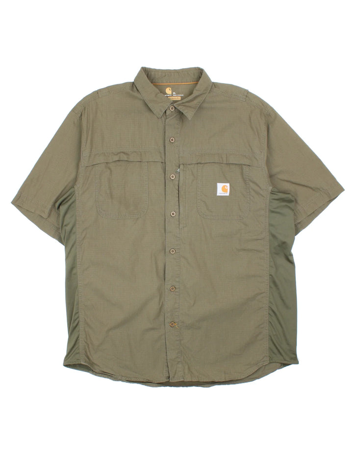 Carhartt Shirt in a green colourway, button up and has multiple tech style pockets with the logo embroidered on the front.