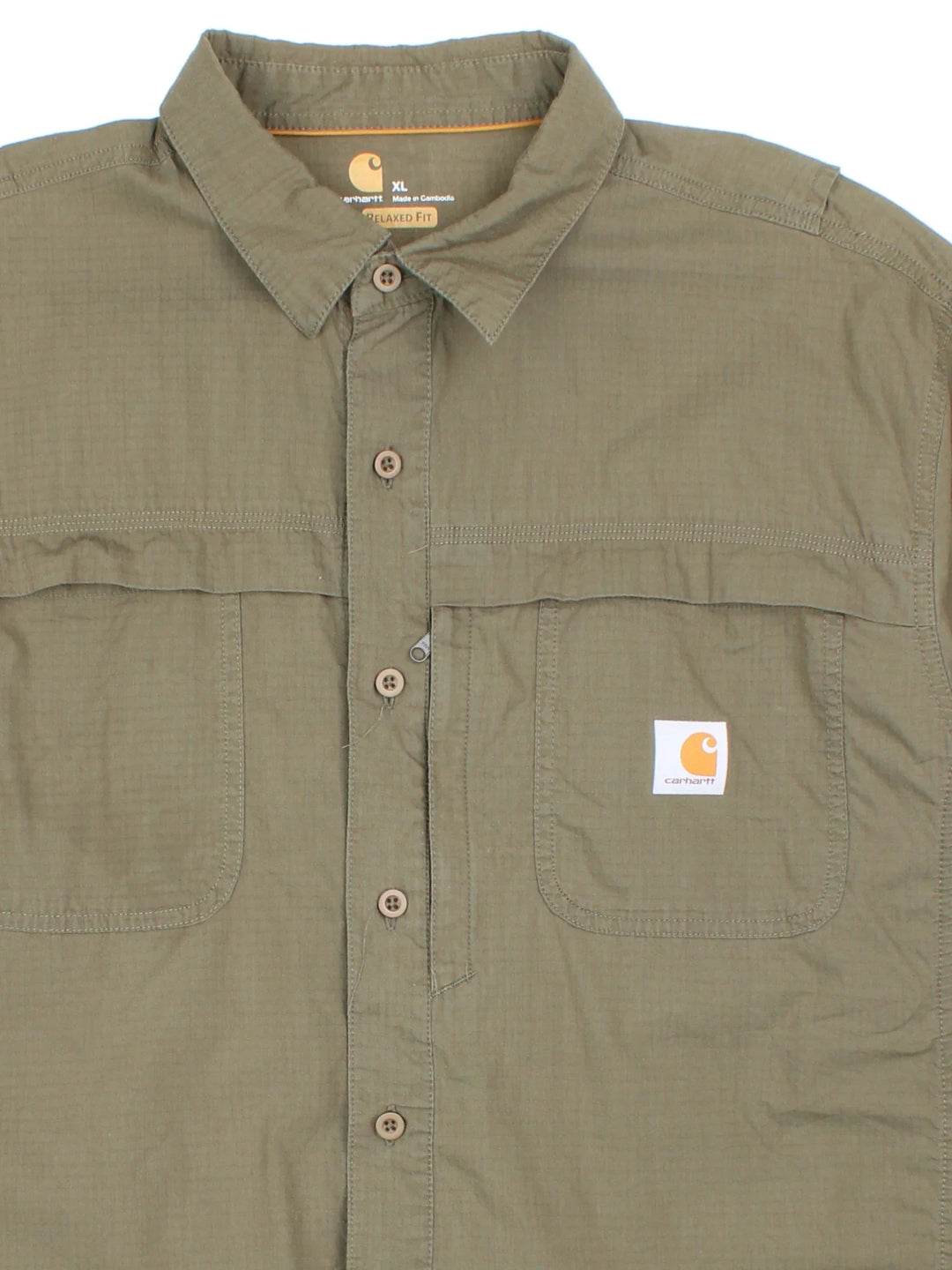 Carhartt Shirt in a green colourway, button up and has multiple tech style pockets with the logo embroidered on the front.