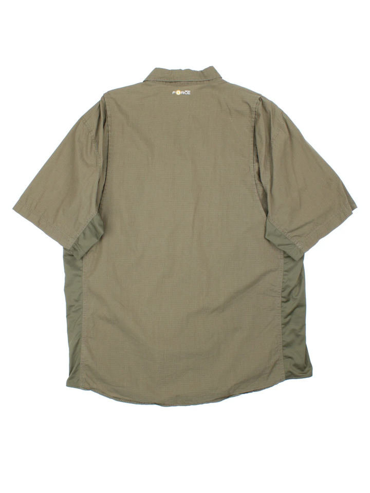 Carhartt Shirt in a green colourway, button up and has multiple tech style pockets with the logo embroidered on the front.