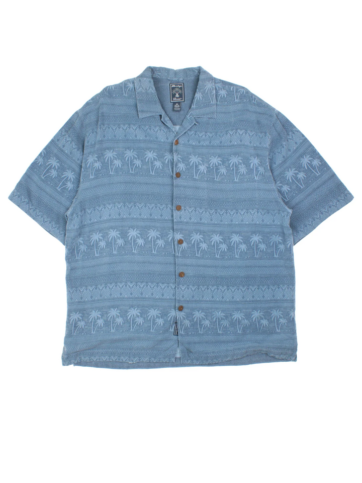 Vintage Hawaiian Shirt in a blue colourway with palm tree pattern all over, button up and has a chest pocket.