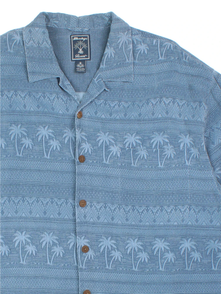 Vintage Hawaiian Shirt in a blue colourway with palm tree pattern all over, button up and has a chest pocket.