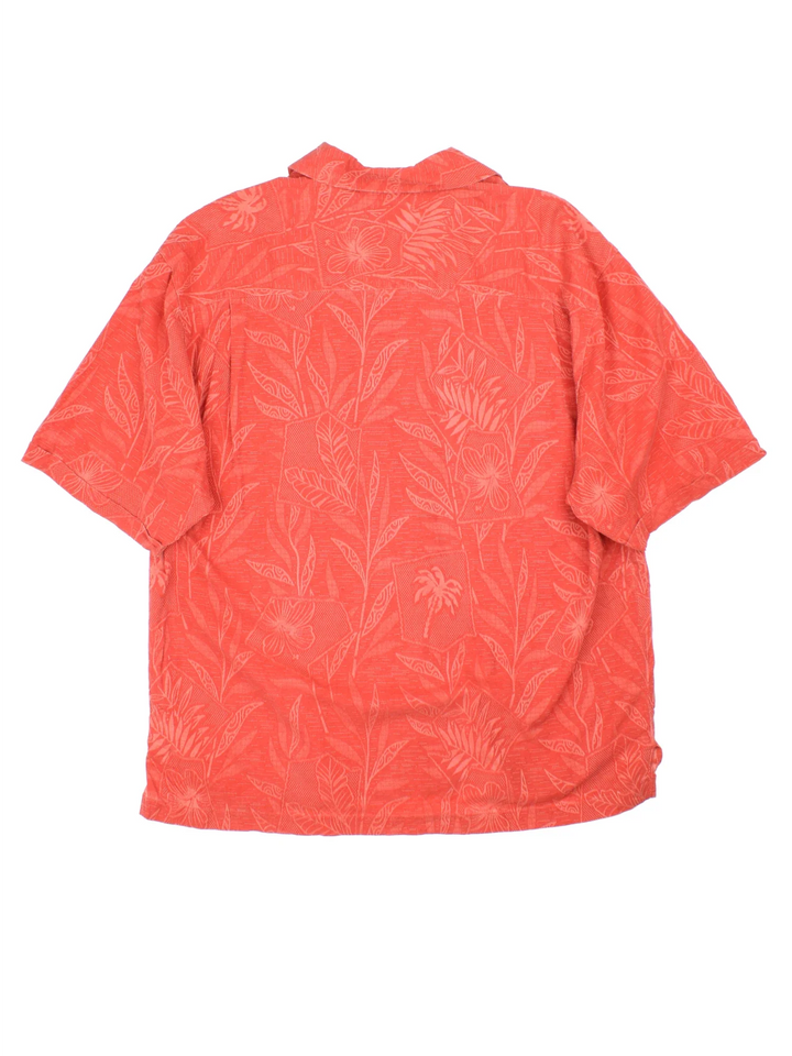 Vintage Hawaiian Shirt in a orange colourway with all over floral leaf print. Button up and has a front chest pocket.