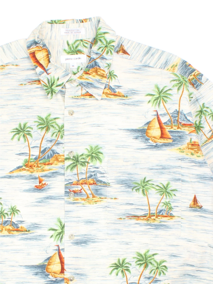 Vintage Pierre Cardin Shirt in a white/blue colourway with all over Hawaiian print. Button up and front chest pocket.