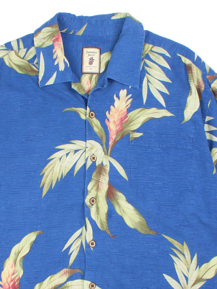 Vintage Hawaiian Shirt in a blue colourway with all over palm print. Button up with front pocket detail.