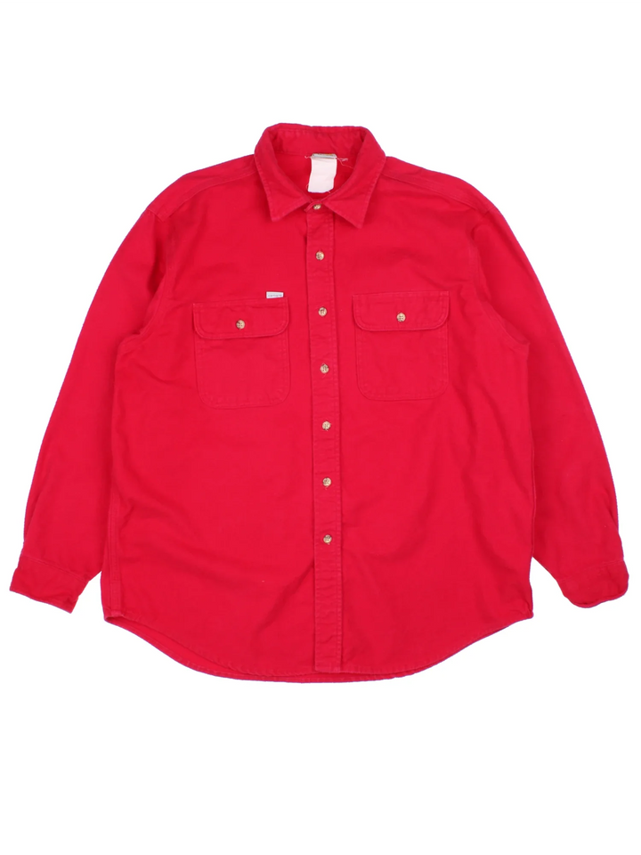 Vintage Carhartt Heavy Cotton Shirt in a red colourway, button up and has double chest pockets with the logo tab embroidered on the front.