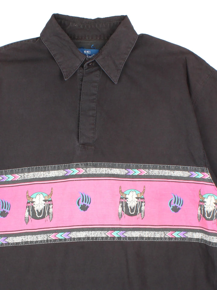 Vintage Wrangler Western Shirt in a black colourway, pullover with a button up collar and has western skull pattern stripe across the front.