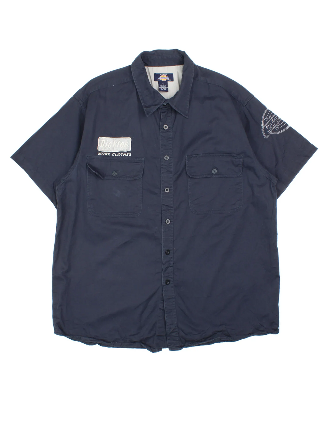 Dickies Work Shirt in a blue colourway, button up and has double chest pockets with the logo embroidered on the front and left sleeve.