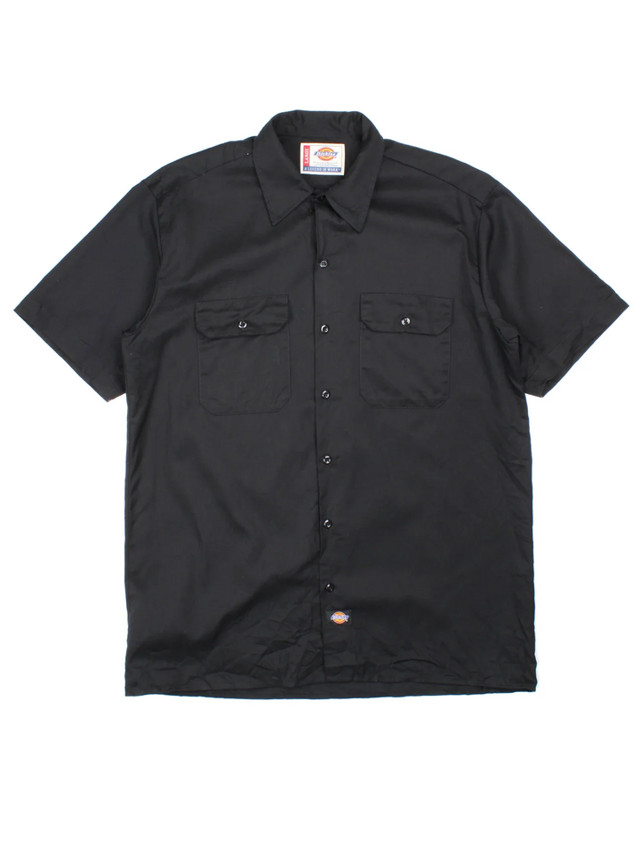 Dickies Work Shirt in a black colourway, button up with double chest pockets and the logo embroidered by the hem.