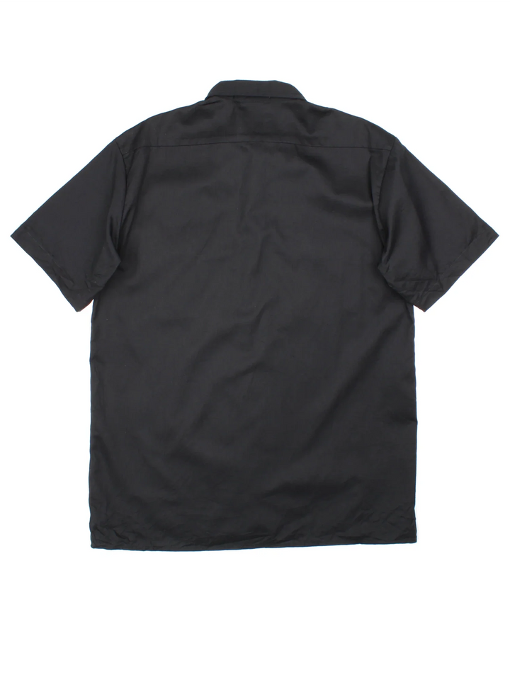 Dickies Work Shirt in a black colourway, button up with double chest pockets and the logo embroidered by the hem.