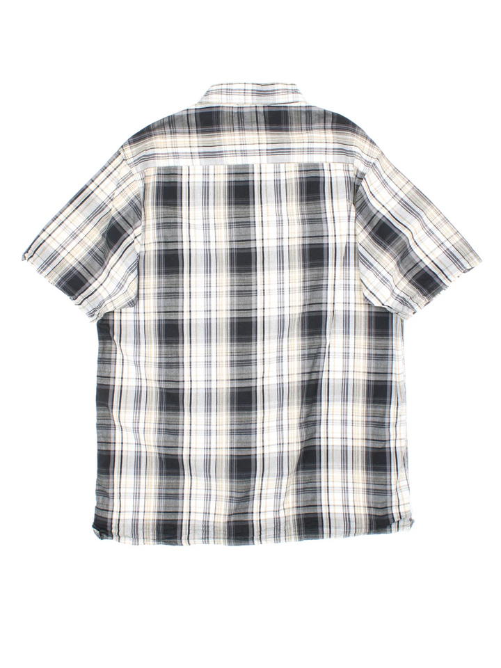 Dickies Shirt in a grey, white and black plaid pattern colourway, button up and has a chest pocket with the logo embroidered on the front.