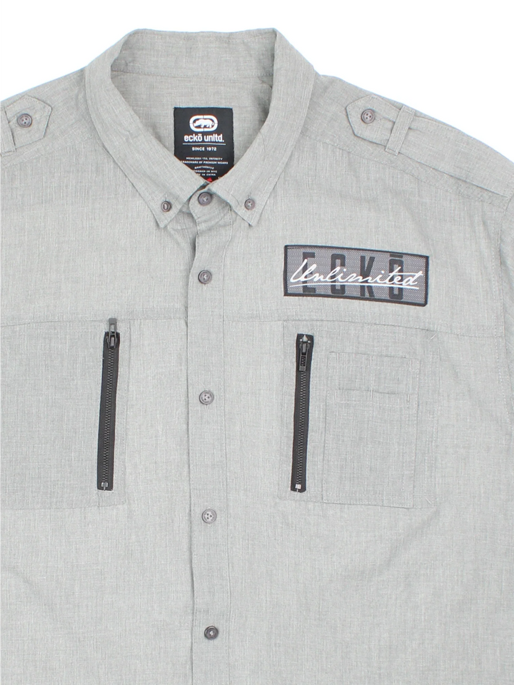 Ecko Unltd Tech Shirt in a grey colourway, button up and has double chest utility style pockets with the logo embroidered on the front and left sleeve.