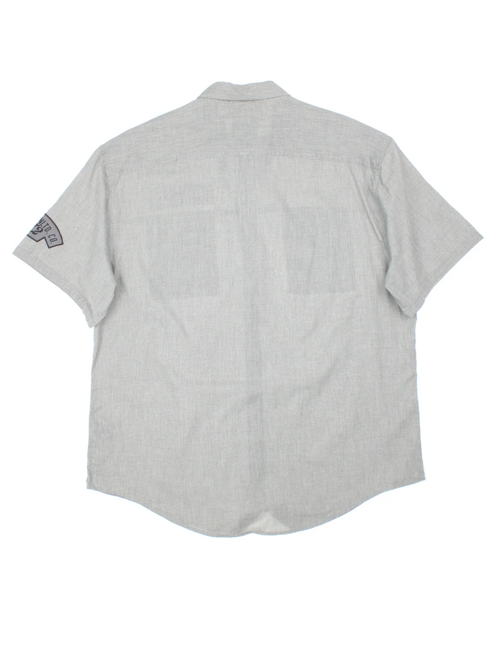 Ecko Unltd Tech Shirt in a grey colourway, button up and has double chest utility style pockets with the logo embroidered on the front and left sleeve.