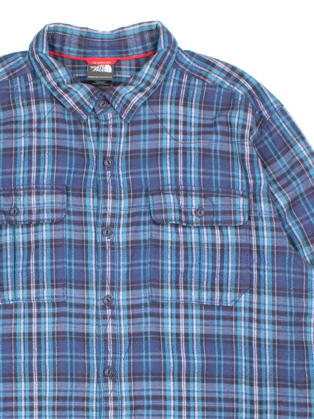 The North Face Flannel Shirt in a blue colourway, button up with two front pockets and all over plaid check pattern.