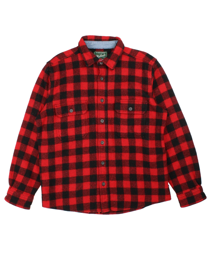 Woolrich Flannel Shirt in a red and black colourway with all over plaid pattern. button up with two pockets on the front.