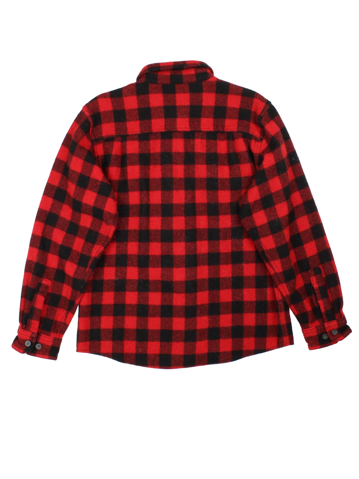 Woolrich Flannel Shirt in a red and black colourway with all over plaid pattern. button up with two pockets on the front.
