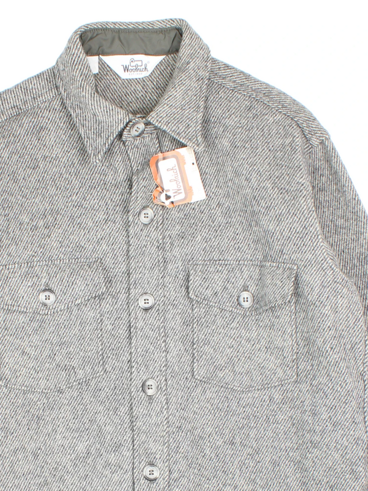 Woolrich Shirt in a grey colourway. Full button up with two pockets on the front.