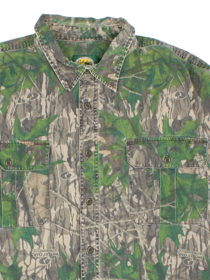 Vintage Cabela's Mossy Oak Camo Shirt in a green and brown colourway, button up and has double chest pockets.