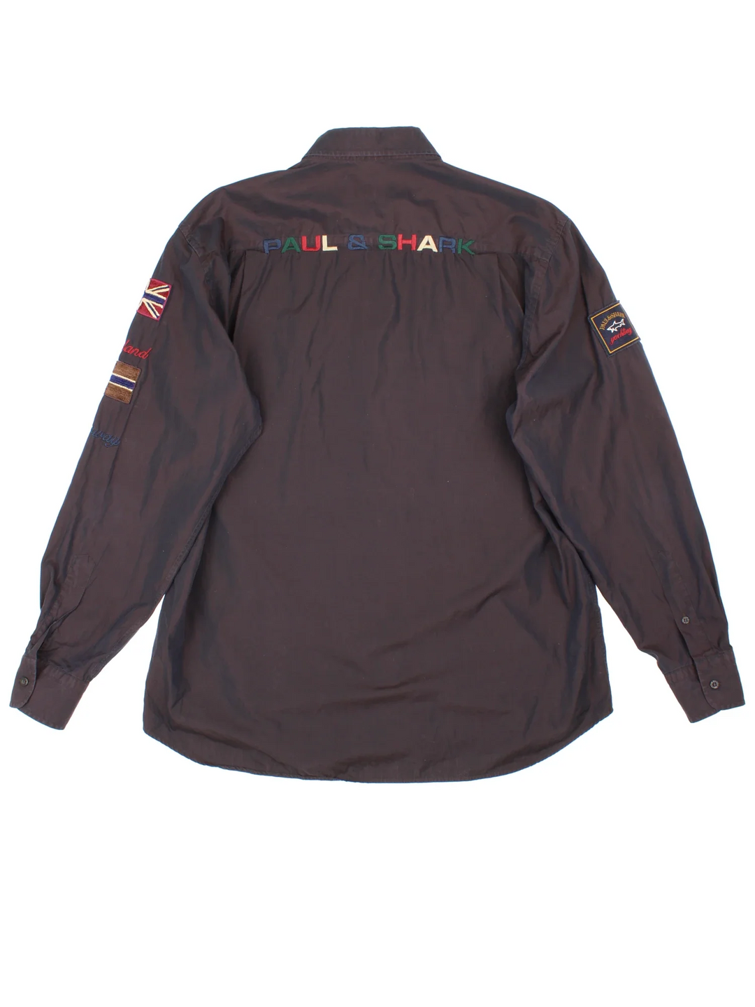 Paul & Shark Yatch Sailing Shirt in a black colourway, button up and has a chest pocket with the logo embroidered on the front alongside text and flags on the front, back and sleeves.