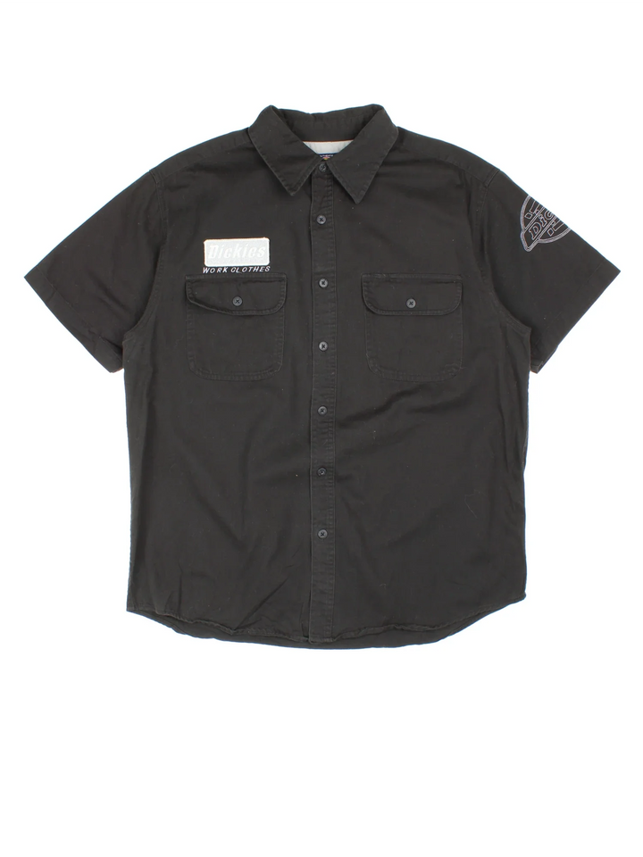 Dickies Work Shirt in a black colourway, button up and has double chest pockets with the logo embroidered on the front and left sleeve.