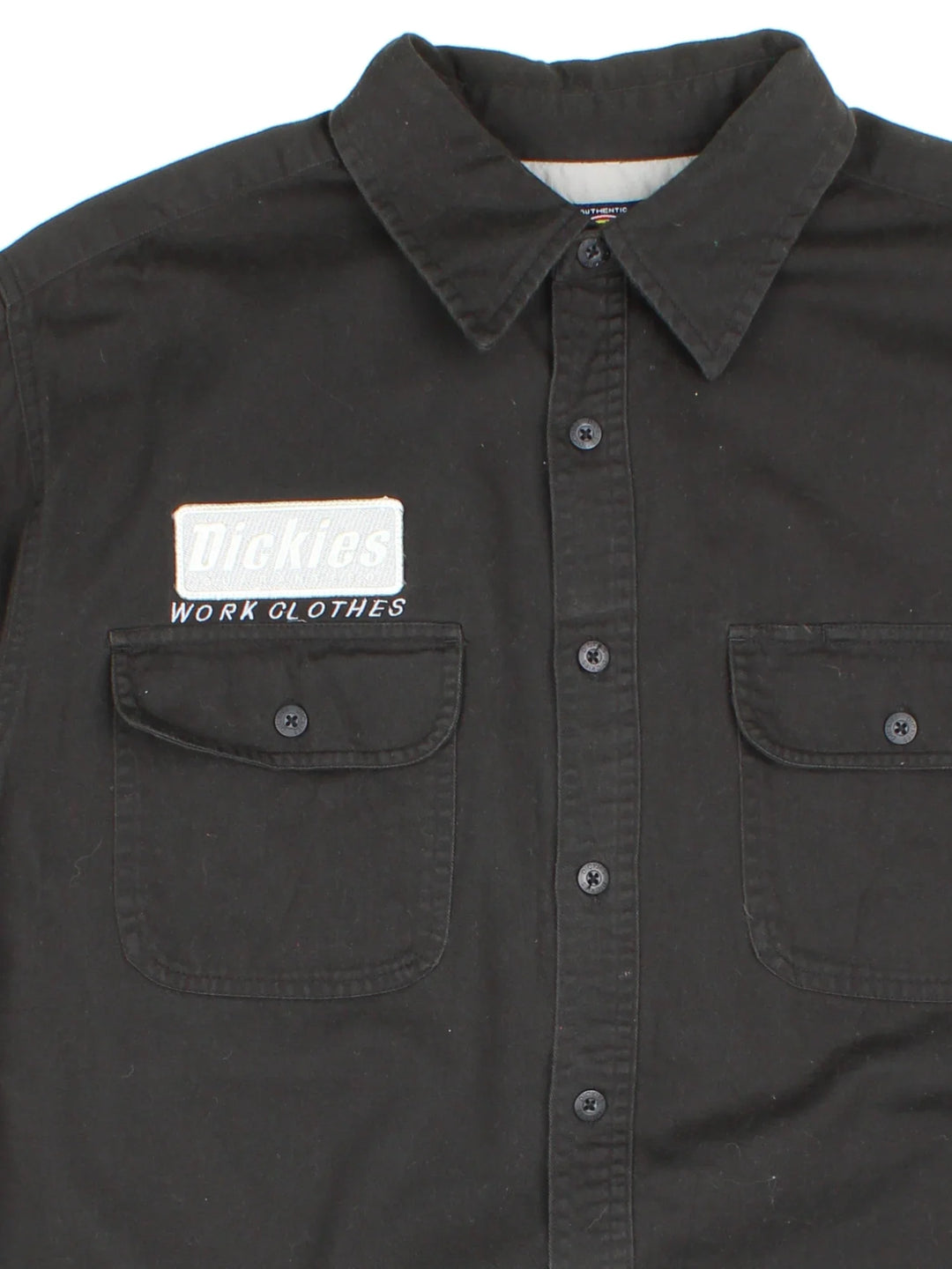 Dickies Work Shirt in a black colourway, button up and has double chest pockets with the logo embroidered on the front and left sleeve.