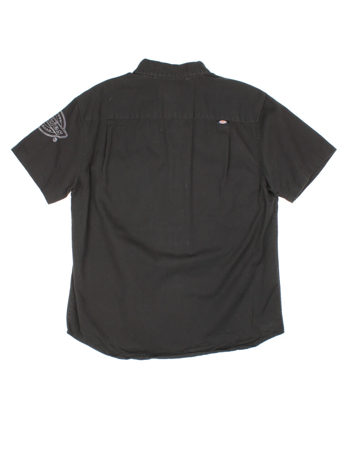 Dickies Work Shirt in a black colourway, button up and has double chest pockets with the logo embroidered on the front and left sleeve.