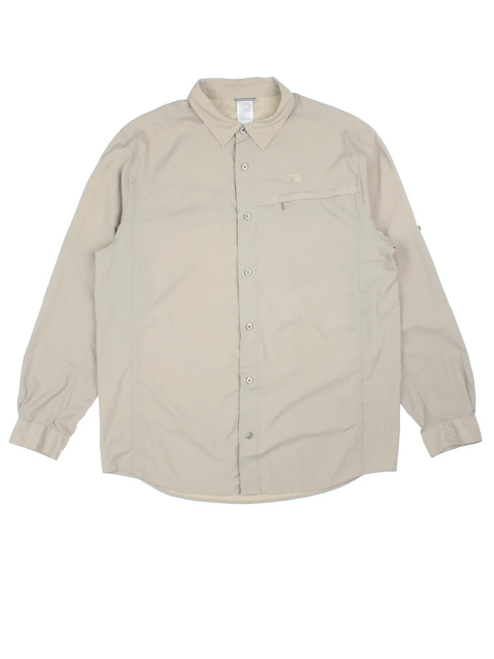 The North Face Ripstop Shirt in a tan colourway, button up and has a chest pocket with the logo embroidered on the front.