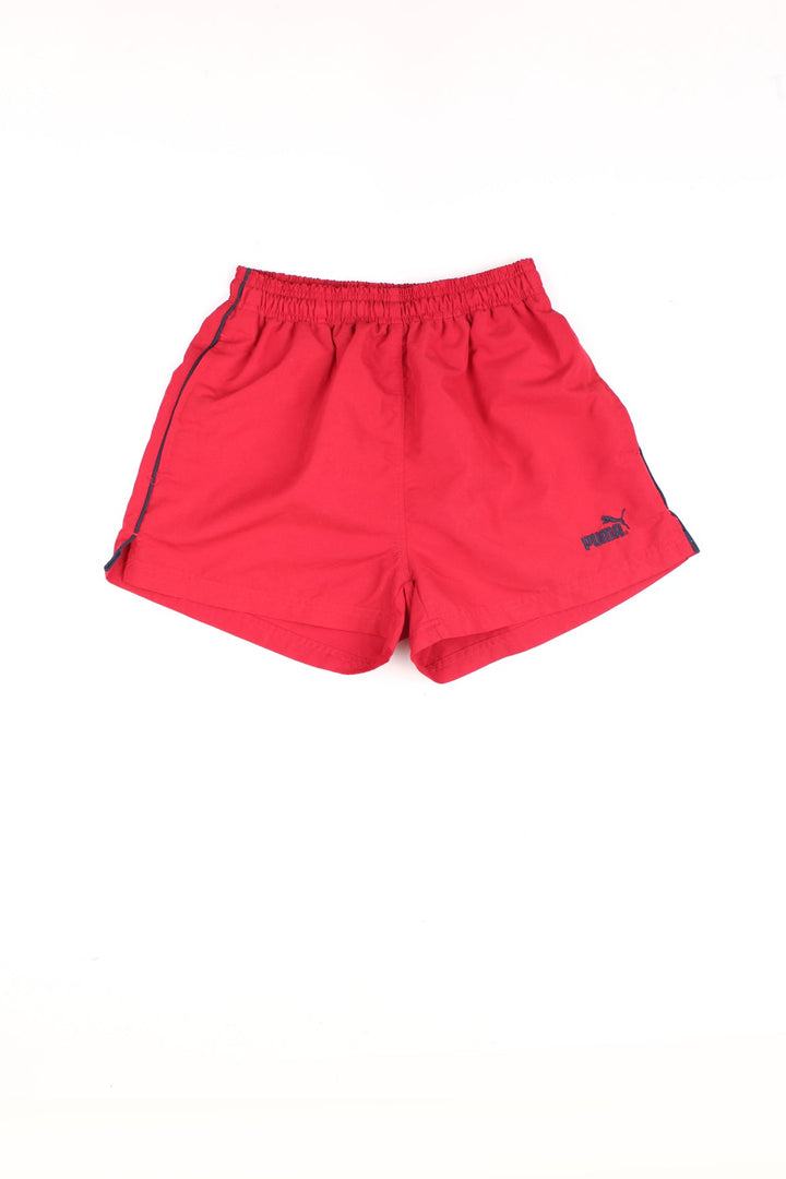 Vintage Puma Shorts in a red colourway with black stripes going down the sides, asdjustable waist, and has the logo embroidered on the front.