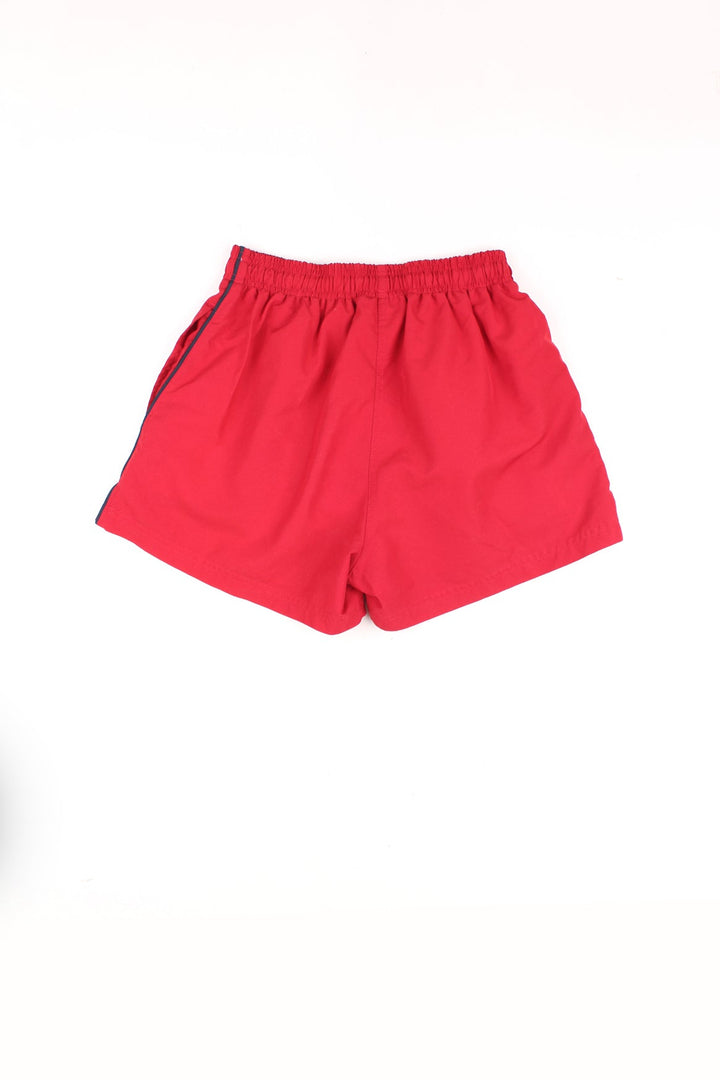 Vintage Puma Shorts in a red colourway with black stripes going down the sides, asdjustable waist, and has the logo embroidered on the front.