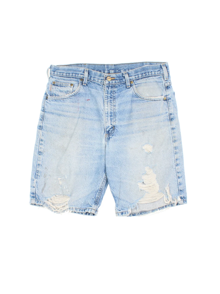 Vintage Carhartt Distressed Denim Shorts in blue colourway with multiple pockets and the logo embroidered on the back.