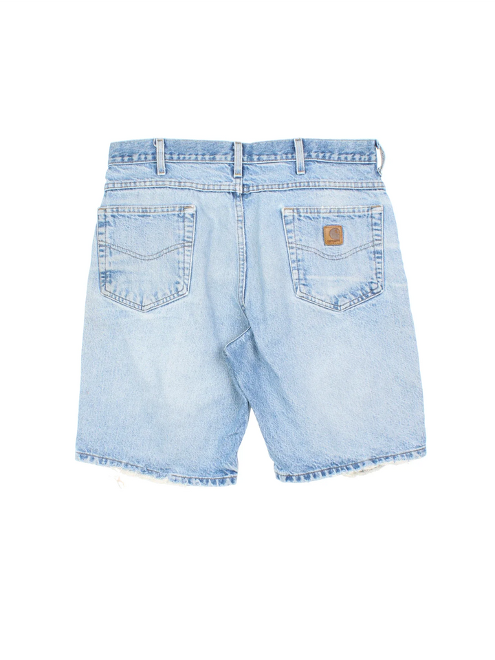Vintage Carhartt Distressed Denim Shorts in blue colourway with multiple pockets and the logo embroidered on the back.