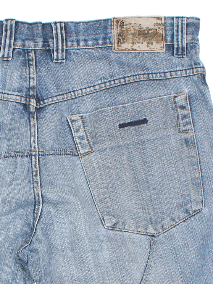 Vintage Y2K Denim Jorts in blue colourway with multiple pockets, contrast stitching and leather logo patch embroidered on the back.