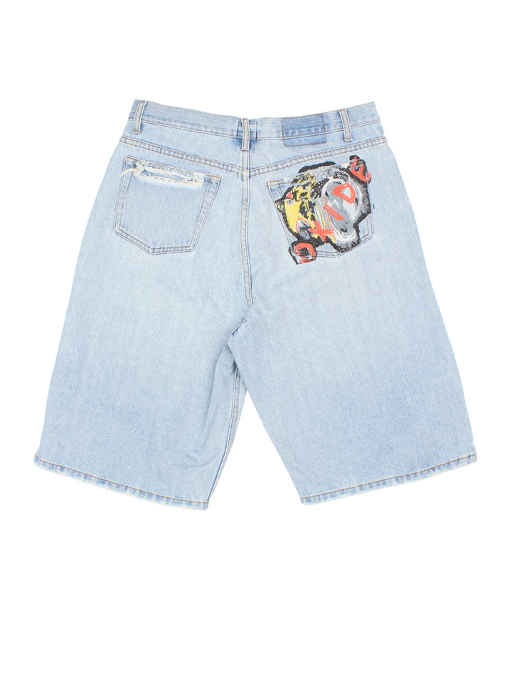 Y2K Oxide Denim Jorts in blue colourway. Multiple pockets and distressed detail, contrast stitching and painted logo on the back.