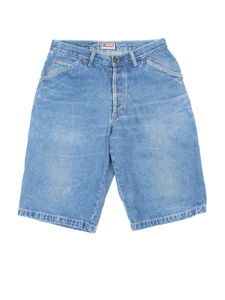 Y2K Denim Jorts in blue colourway with multiple pockets and the logo embroidered on the back.