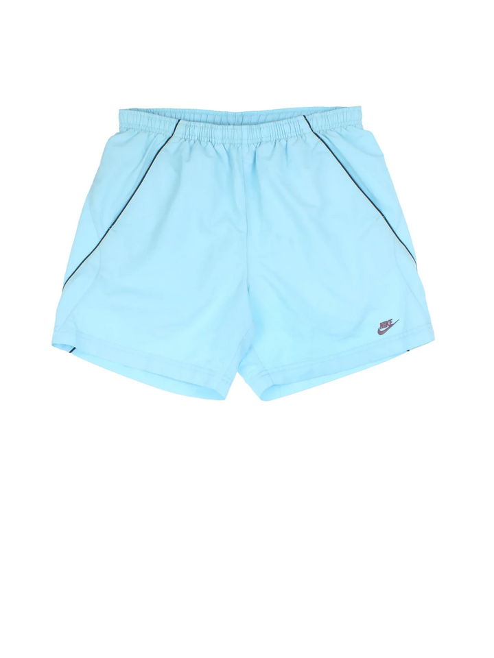 Vintage Nike Sports Shorts in blue colourway. Side pockets, contrast piping detail, mesh lining, and the logo embroidered on the front.