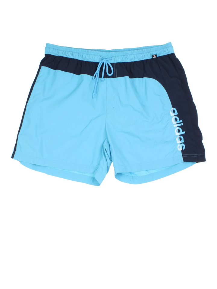 Vintage Adidas Swim Shorts in blue colourway. Drawstring fastening, contrast piping detail, mesh lining, and the logo embroidered on the front.