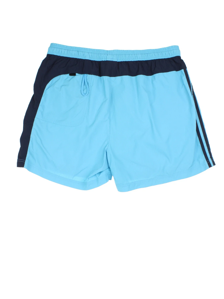 Vintage Adidas Swim Shorts in blue colourway. Drawstring fastening, contrast piping detail, mesh lining, and the logo embroidered on the front.