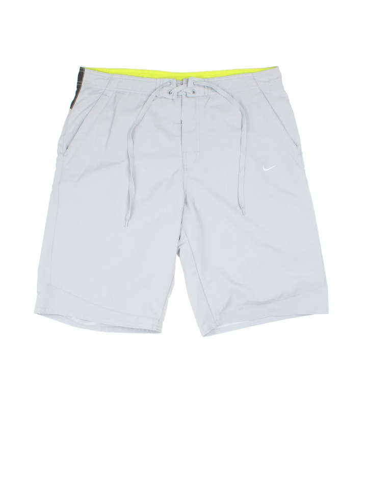 Vintage Nike Swim shorts in grey colourway with lace up fastening, mesh insert and the logo embroidered on the front.