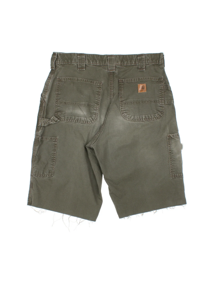 Carhartt Cut Off Shorts in green colourway. Zip fly fastening with multiple pockets, frayed hem and embroidered branding on the back.