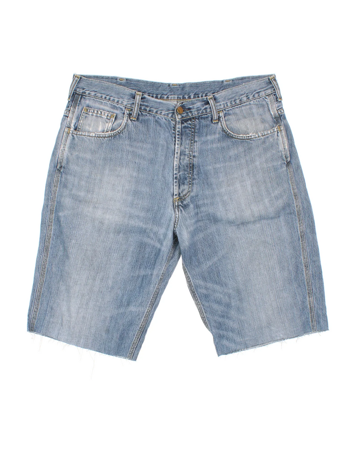 Carhartt Cut Off Shorts in blue colourway. Zip fly fastening with multiple pockets, frayed hem and embroidered branding on the back.